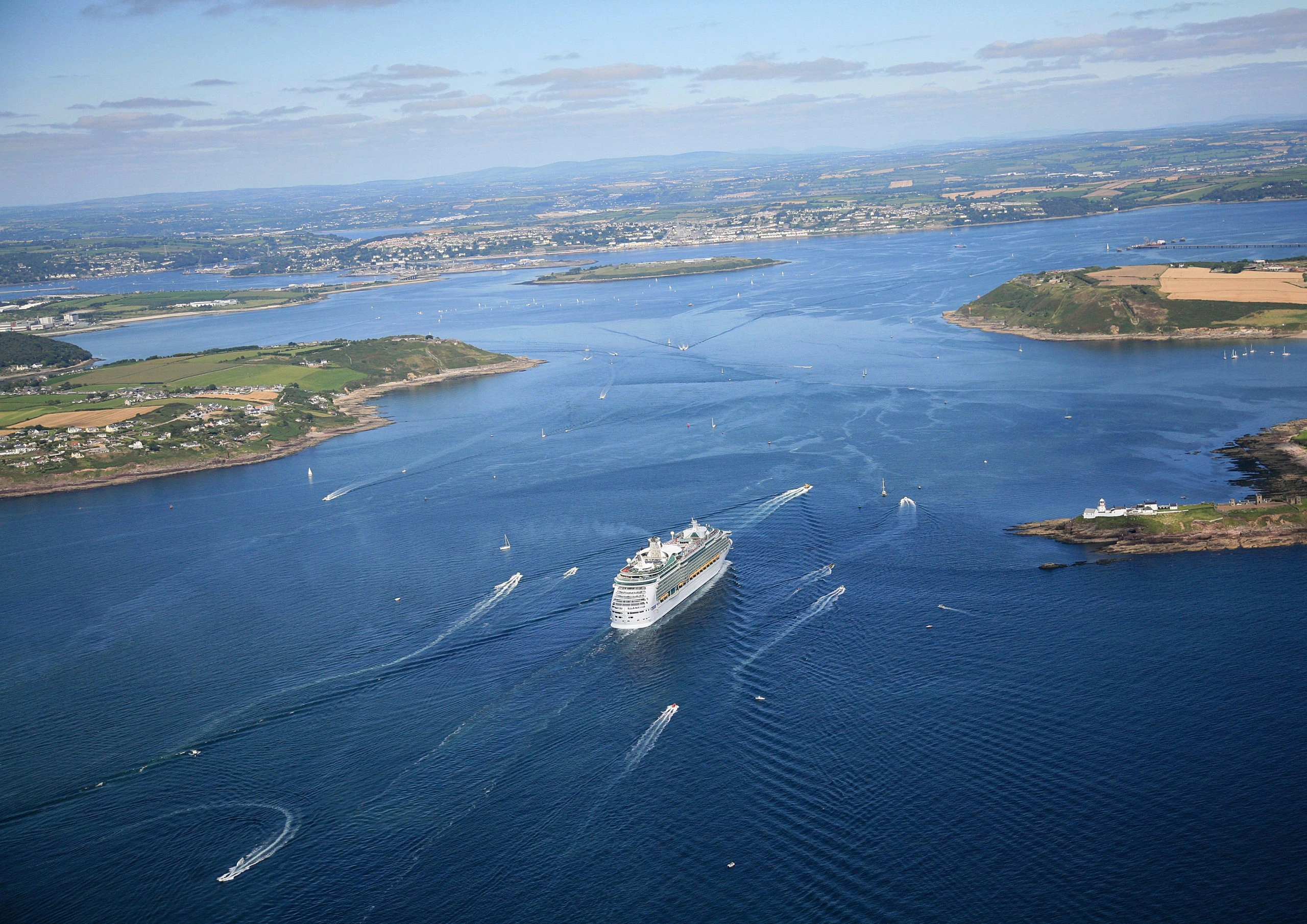 Wide aerial view of Cork Harbour, its coastline and a ship entering the harbour